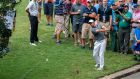Rory McIlroy hits his ball up a cart path and back onto the tenth green after an errant shot. Photograph: EPA