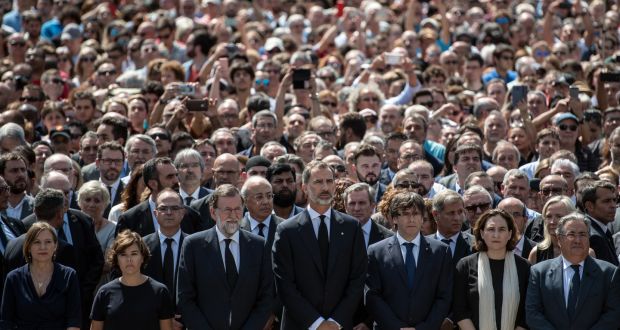 King Felipe VI of Spain and Spanish prime minister Mariano Rajoy join other dignitaries and residents of Barcelona in Placa de Catalunya on Friday to observe a minute’s silence for the victims of the prevoius day’s terrorist attack. Photograph: Carl Court/Getty Images