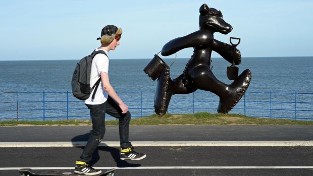 A skateboarder passing a bronze teddy bear sculpture by Patrick O’Reilly at the seafront in Greystones. Photograph: Eric Luke
