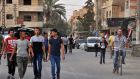 Syrians walk in the street in Deir al-Zor after Syria’s army broke a years-long Islamic State siege on the government enclave. Photograph: Stringer/AFP/Getty Images