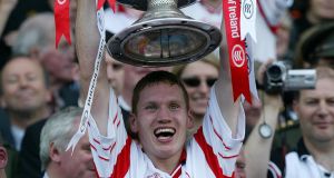 Tyrone’s Cormac McAnallen lifts the Sam Maguire after the All-Ireland final victory over Armagh in 2003. ©INPHO/Patrick Bolger