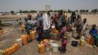 Displaced people collect water in Muna Garage camp for the displaced on the outskirts of Maiduguri, northeast Nigeria. Photograph: Sally Hayden