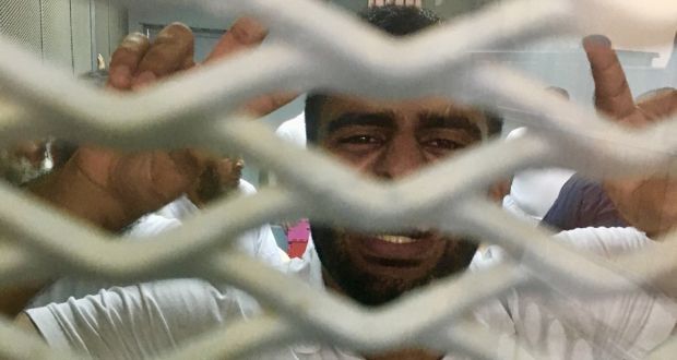 Dubliner Ibrahim Halawa celebrates moments after his acquittal by an anti-terrorism court at the Wadi Natrun prison outside Cairo on Monday. Photograph: Declan Walsh/New York Times
