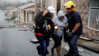 Rescue workers help people after the area was hit by Hurricane Maria in Guayama, Puerto Rico on Wednesday. Photograph:  Carlos Garcia Rawlins/Reuters
