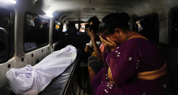 The mother of a stampede victim sits beside her son’s body as it is transported from a hospital in Mumbai, India, on Friday. Photograph: Danish Siddiqui/Reuters