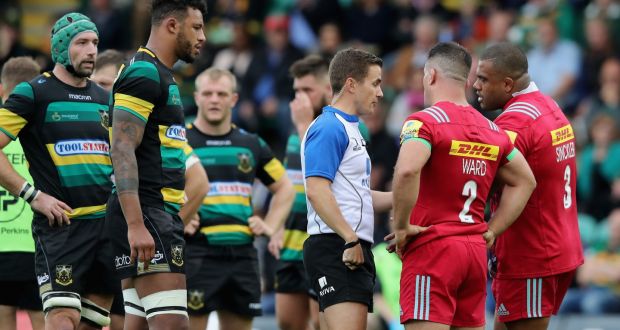 Luke Pearce talks to Harlequins captain Dave Ward as a penalty is awarded against Kyle Sinckler. Photograph:  David Rogers/Getty Images