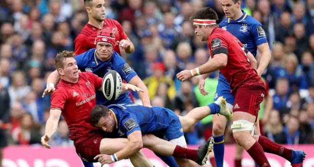 Munster’s Chris Farrell offloads as he is tackled by Leinster ’s Josh van der Flier and Robbie Henshaw at the Aviva Stadium. Photograph: Billy Stickland/Inpho 