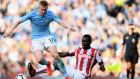 Kevin De Bruyne of Manchester City in action against Mame Biram Diouf of Stoke City  during the Premier League match  at Etihad Stadium. Photograph: Laurence Griffiths/Getty Images