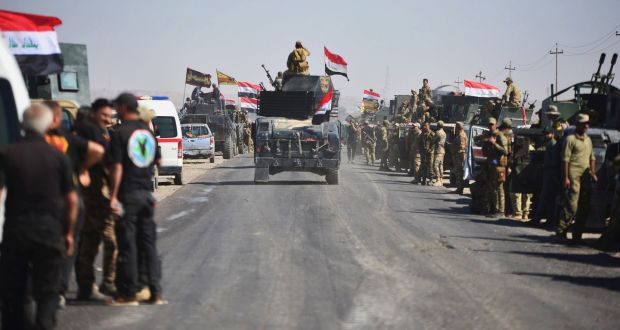 Members of Iraqi federal forces  advance in military vehicles in Kirkuk, Iraq on Monday. Photograph: Reuters