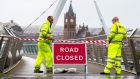 Staff from the Northern Ireland Road Service close the Peace Bridge in Derry, as Hurricane Ophelia hits the UK. Photograph: Liam McBurney/PA Wire 