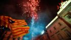 Catalan separatist flags are held up as fireworks go off in Sant Jaume Square in front of the Catalan regional government headquarters during celebratrions after the Catalan regional parliament declared independence from Spain in Barcelona. Photograph: Yves Herman/Reuters