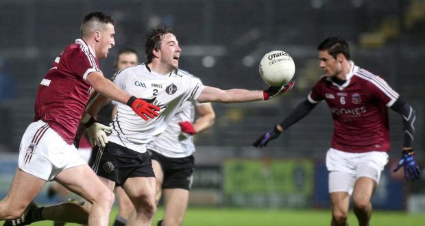  Omagh’s Gregory Murray is challenged by  Slaughtneil’s Meehaul McGrath. Photograph: Lorcan Doherty/Inpho