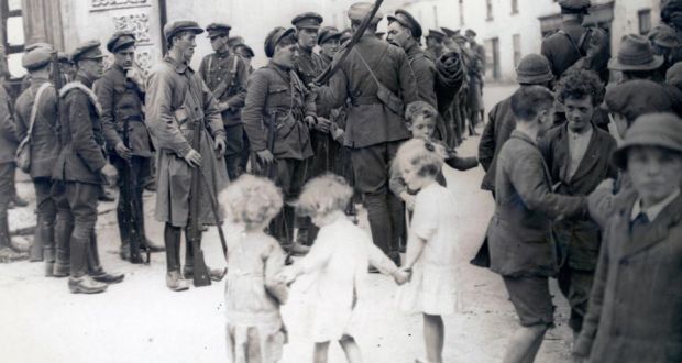 Atlas of the Irish Revolution: the book includes this image of National Army soldiers and barefoot children after the taking of Bruff, Co Limerick, from the IRA in August 1922. Photograph courtesy of the National Library of Ireland