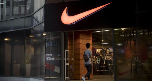 A man enters a Nike shop  in Bangkok, Thailand. File photographer: Brent Lewin/Bloomberg