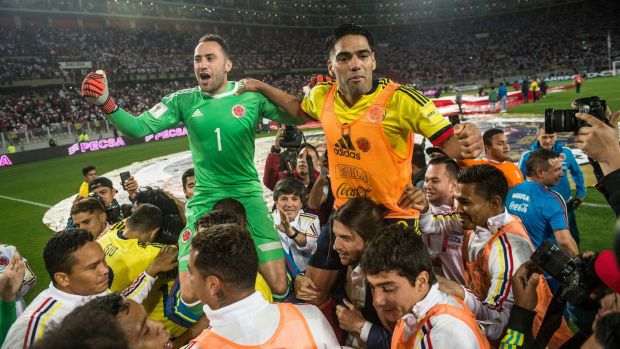 Colombia celebrate their 1-1 draw with Peru which secured their place at the World Cup and consigned their opposition to a playoff. Photograph: Ernesto Benavides/AFP