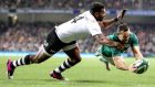 Ireland’s Dave Kearney scores a try despite the efforts of Timoci Nagusa of Fiji during the the game at the  Aviva stadium. Photograph: Dan Sheridan/Inpho