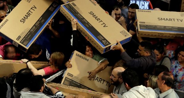 Shoppers reach out for television sets as they compete to purchase retail items on Black Friday at a store in Sao Paulo. Photograph: Paulo Whitaker /Reuters