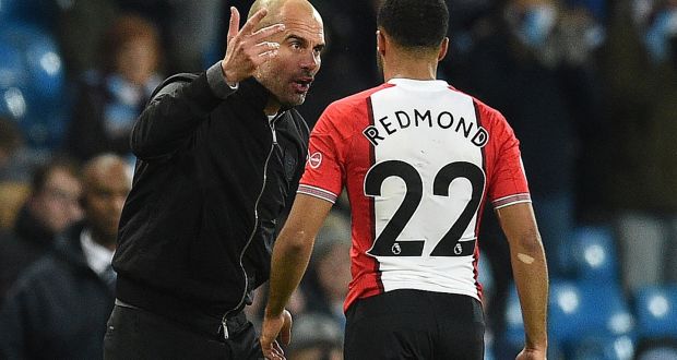  Pep Guardiola talks with Southampton’s English midfielder Nathan Redmond after their match at the Etihad Stadium. Photograph: Getty Images