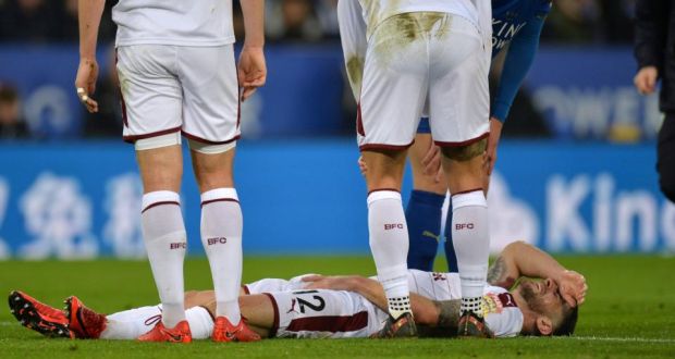 Burnley’s Robbie Brady goes down injured after a collision with Leicester City’s Harry Maguire. Photo: Peter Powell/Reuters