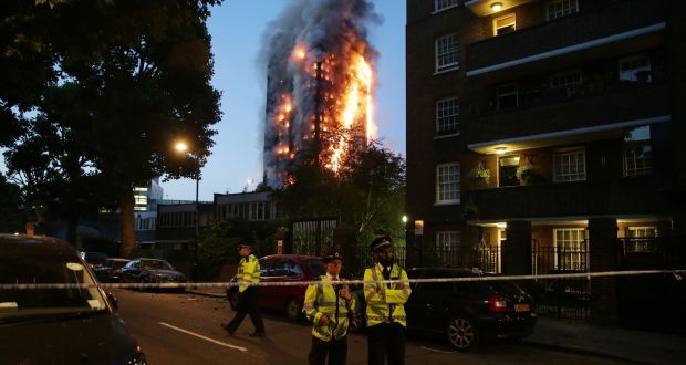In a photo rated as one of AFP’s pictures of the year 2017,  police guard  a security cordon as a huge fire engulfs the Grenfell Tower early on June 14th in west London. File photograph: Daniel Leal-Olivas/AFP/Getty Images