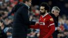 Liverpool manager Jürgen Klopp greets Mohamed Salah as he is substituted, with Everton manager Sam Allardyce standing nearby.  Photograph: Phil Noble/Reuters 