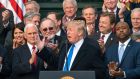 US president Donald Trump celebrates the passage of a major tax overhaul with Republican members of the House and Senate on the  South Lawn of the White House on Wednesday. Photograph: Jim Lo Scalzo/EPA