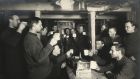 Members of the Imperial Trans-Antarctic Expedition  1914-17, led by Ernest Shackleton, drink a toast to ‘sweethearts and wives’ on board the Endurance. Photograph: Frank Hurley/Scott Polar Research Institute, University of Cambridge/Getty Images