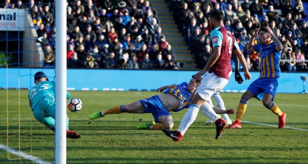 Shrewsbury Town’s James Bolton pokes past West Ham United’s Joe Hart during their FA Cup clash. Photo: Andrew Yates/Reuters