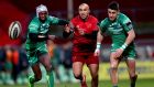 Connacht’s Niyi Adeolokun and Tiernan O’Halloran in action against Munster’s Simon during Munster’s 39-13 win at Thomond Park. Photograph: James Crombie/Inpho