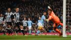 Manchester City’s   Sergio Agüero scores the opening goal past Newcastle’s Karl Darlow at Etihad Stadium on Saturday. Photograph:  Stu Forster/Getty Images