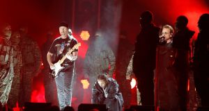  Kendrick Lamar (C) performs with U2’s The Edge (L) and Bono. Photograph: Lucas Jackson/Reuters