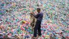 A Chinese labourer sorts plastic bottles for recycling in Dong Xiao Kou village, on the outskirts of Beijing. Photograph: Fred Dufour/AFP/Getty Images
