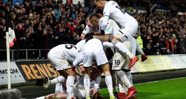 Swansea City’s Samuel Clucas celebrates scoring their third goal with team-mates in the Premier League game against Arsenal at the Liberty Stadium. Photograph: Rebecca Naden/Reuters 