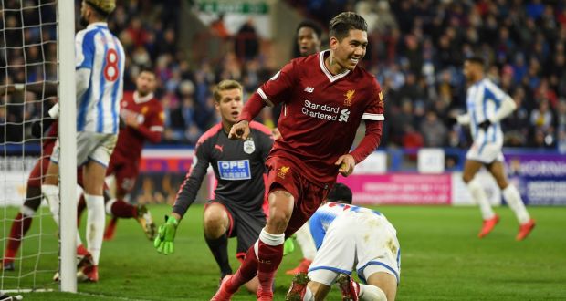 Roberto Firmino of Liverpool celebrates as he scores their second goal past goalkeeper Jonas Lossl of Huddersfield Town  during the Premier League match at John Smith’s Stadium. Photograph: Gareth Copley/Getty Images