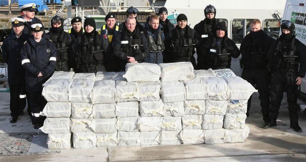 Armed Naval and Garda personnel with the cocaine which was seized from a yacht off the west coast of Ireland, in the harbour at Castletown Bere in Co Cork in 2008. Photograph: Niall Carson/PA Wire