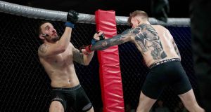 Portuguese MMA fighter Joao Carvalho (left) during his fight with Charlie Ward at the National Stadium in Dublin. Photograph: Dave Fogarty