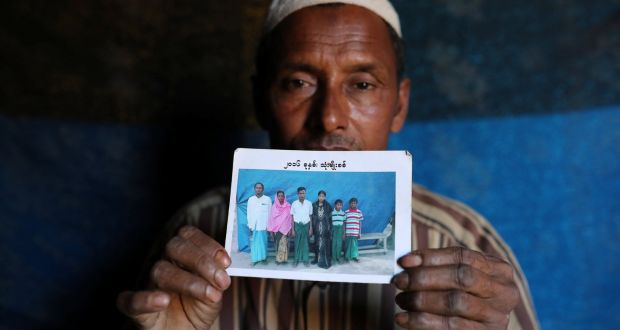 Abdu Shakur, whose son Rashid Ahmed was among 10 Rohingya men killed by Myanmar security forces and Buddhist villagers on September 2nd, 2017, holds a family picture at Kutupalong camp in Cox’s Bazar, Bangladesh. Photograph: Mohammad Ponir Hossain/Reuters