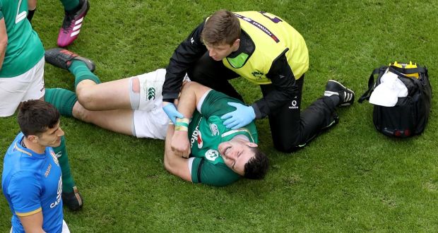 Ireland’s Robbie Henshaw is treated on the pitch after injuring his shoulder during the Six Nations match against Italy at the Aviva stadium. Photograph: Tommy Dickson/Inpho