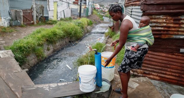  A resident of the Masiphumelele informal settlement collects drinking water from a communal municipal tap in Cape Town, South Africa. Photograph: Nic Bothma/EPA