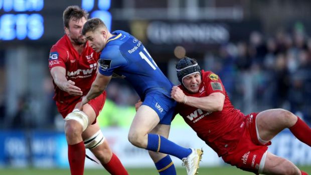 Leinster’s Jordan Larmour is tackled by David Bulbring and Ryan Elias of Scarlets during the Guinness Pro 14 game at the RDS. Photograph: Byran Keane/Inpho