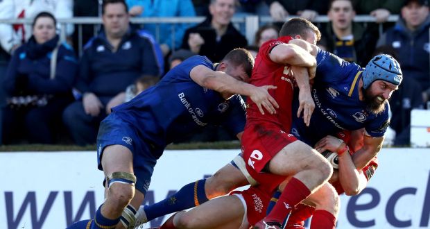 Leinster’s Scott Fardy drives towards the tryline  despite the efforts of Jonathan Evans and Corey Baldwin of Scarlets during the Guinness Pro 14 game at the  RDS. Photograph: Byran Keane/Inpho