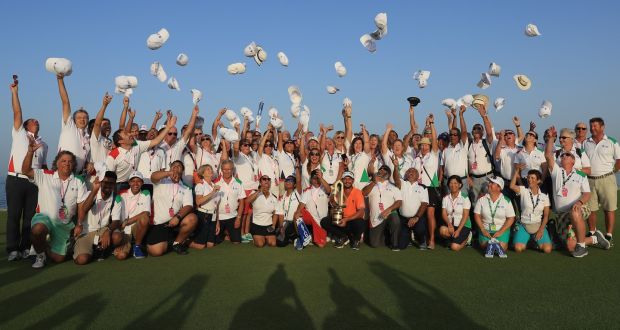 Joost Luiten of the Netherlands celebrates with the trophy and the volunteers after the final round of the NBO Oman Open at Al Mouj Golf  in Muscat. Photograph: Andrew Redington/Getty Images