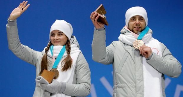 Alexander Krushelnytsky (right) and Anastasia Bryzgalova during the medal ceremony for the Curling Mixed Doubles. Photograph: EPA