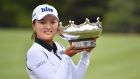 Jin Young Ko from Korea celebrates with her trophy after winning the Australian Women’s Open golf tournament at the Kooyonga Golf Club, in Adelaide. Photo: David Mariuz/EPA