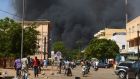 Black smoke rises as the capital of Burkina Faso comes under multiple attacks. Photograph: Ahmed Ouoba/AFP/Getty Images