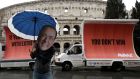 An activist wearing a mask of Forza Italia party leader Silvio Berlusconi poses the day after Italy’s general election, in Rome. Photograph: Max Rossi/Reuters
