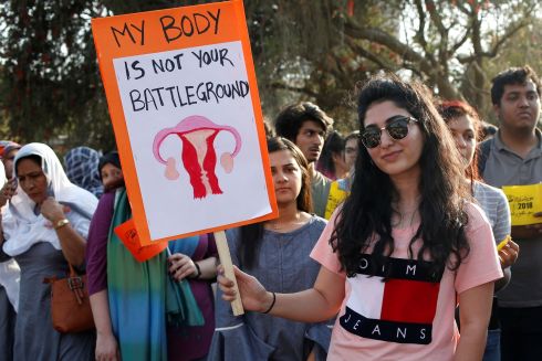 A woman hold sign as she takes part in an Aurat March, or Women's March in Karachi, Pakistan. Photograph: Akhtar Soomro / Reuters
