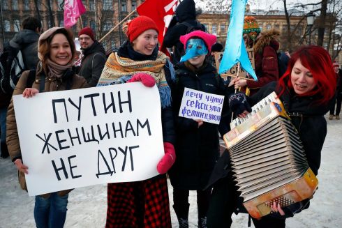Members of the Russian feminist movement carry a placard 'Putin is not Women's friend' as they attend a rally dedicated to the struggle for women's rights and against the Patriarchate in St. Petersburg, Russia. Photograph: Anatoly Maltsev / Reuters 
