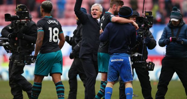Southampton manager  Mark Hughes celebrates with players after their FA Cup Quarter Final victory over Wigan in DW Stadium on Sunday. Photograph: Alex Livesey/Getty Images