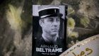 A photograph of Lieut-Col Arnaud Beltrame on a bunch of flowers at the main gate of police headquarters in Carcassonne, France, on Saturday.  Photograph: AP Photo/Emilio Morenatti